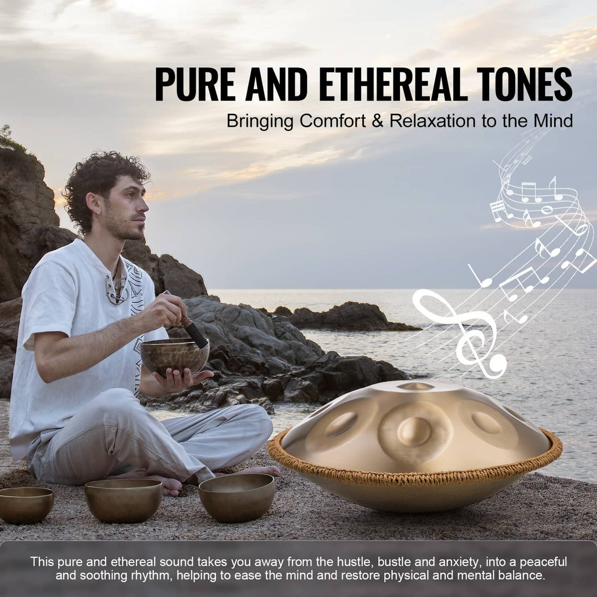 Handpan drum on the ground in front of a seated player, golden tone surface with dimples