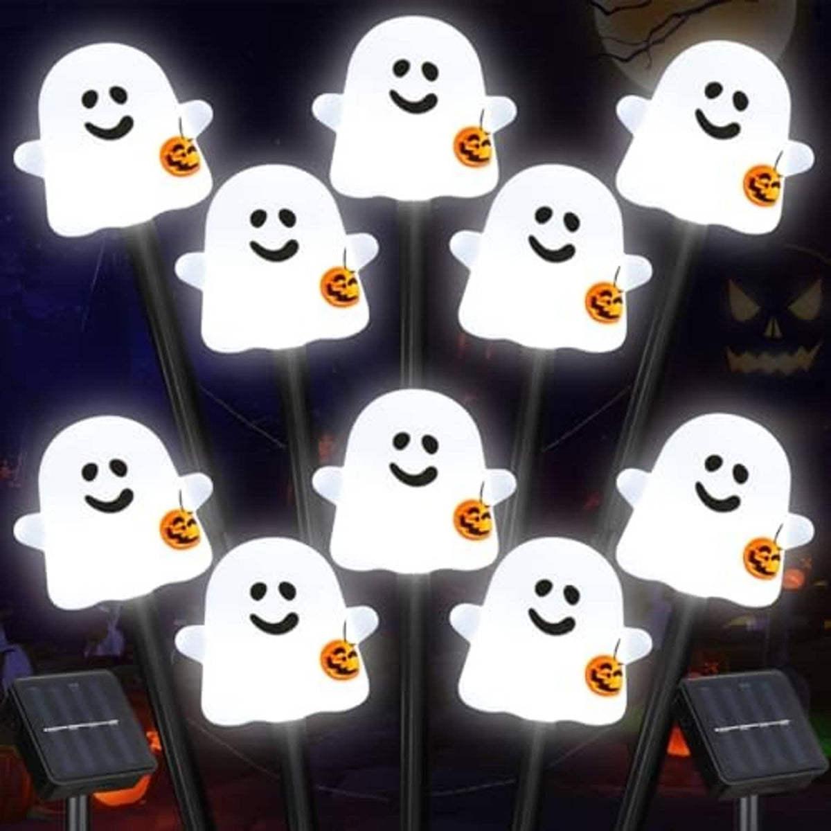 Cluster of white smiling ghost solar pathway lights on stakes with jack-o'-lantern buckets