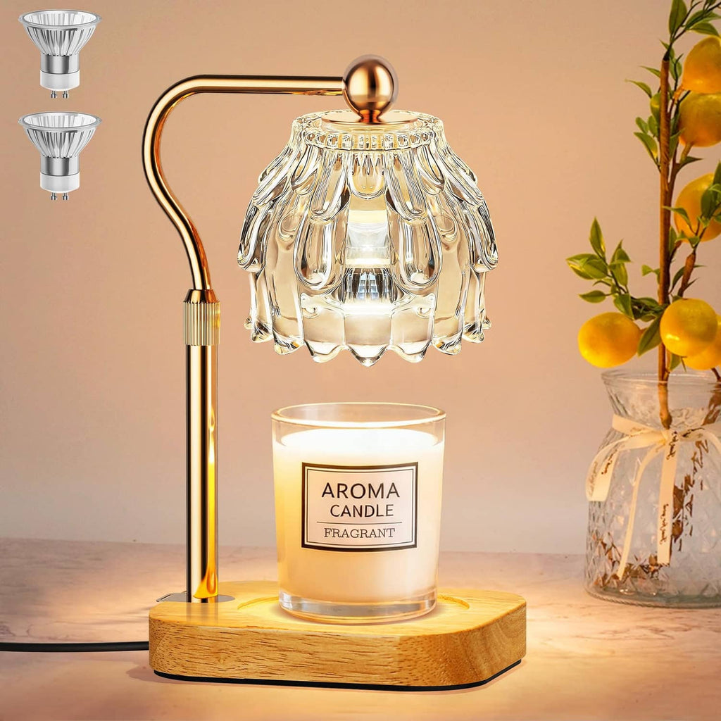 Transparent glass candle warmer lamp with gold curved stand and wooden base