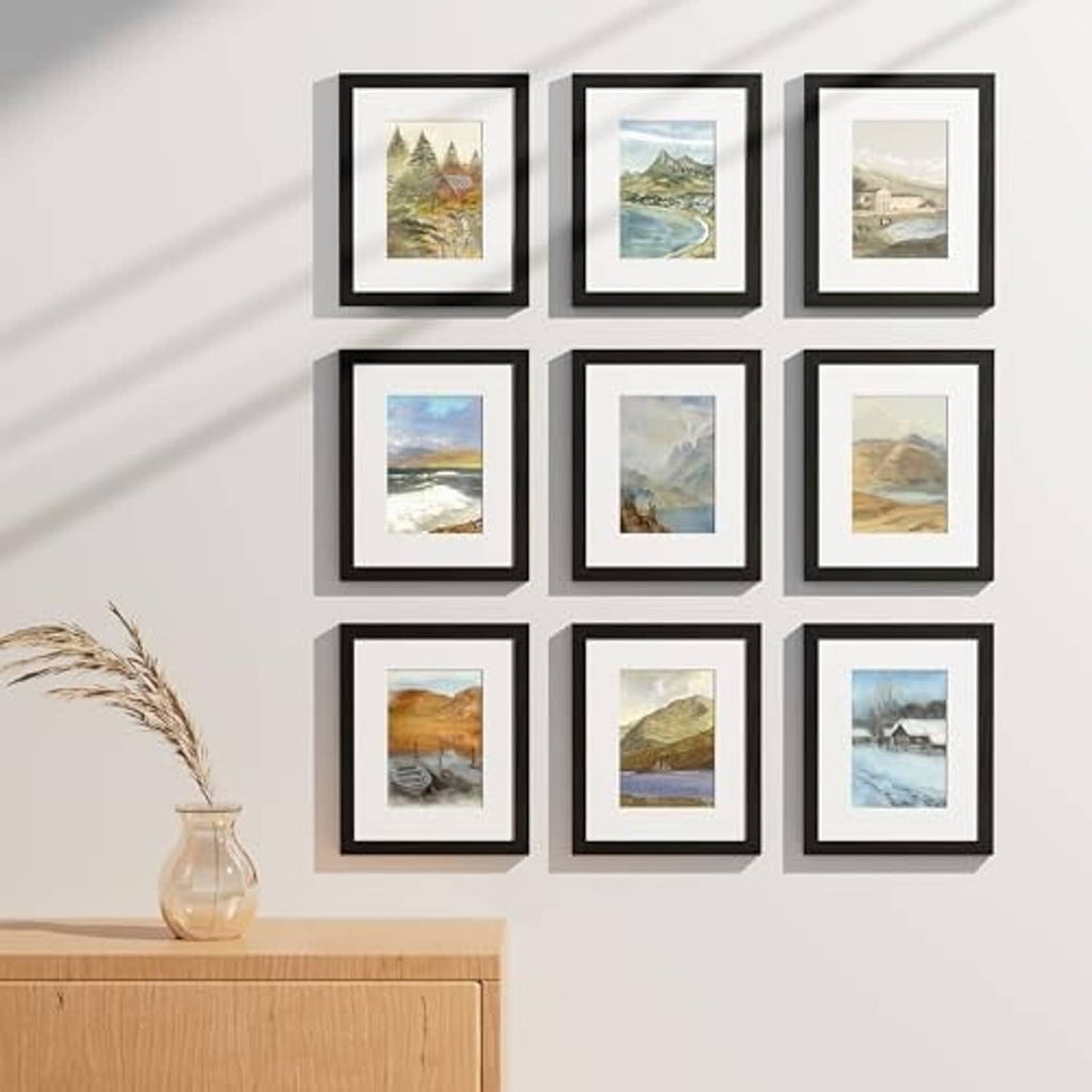 Black 9-piece picture frame set with clear plexiglass fronts, displaying landscape photos