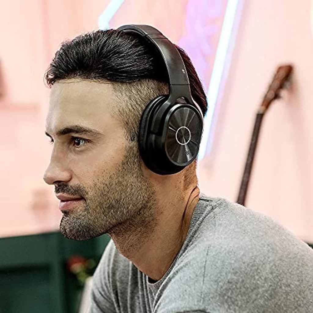 Black over-ear headphones worn over one ear with cushioned earcups
