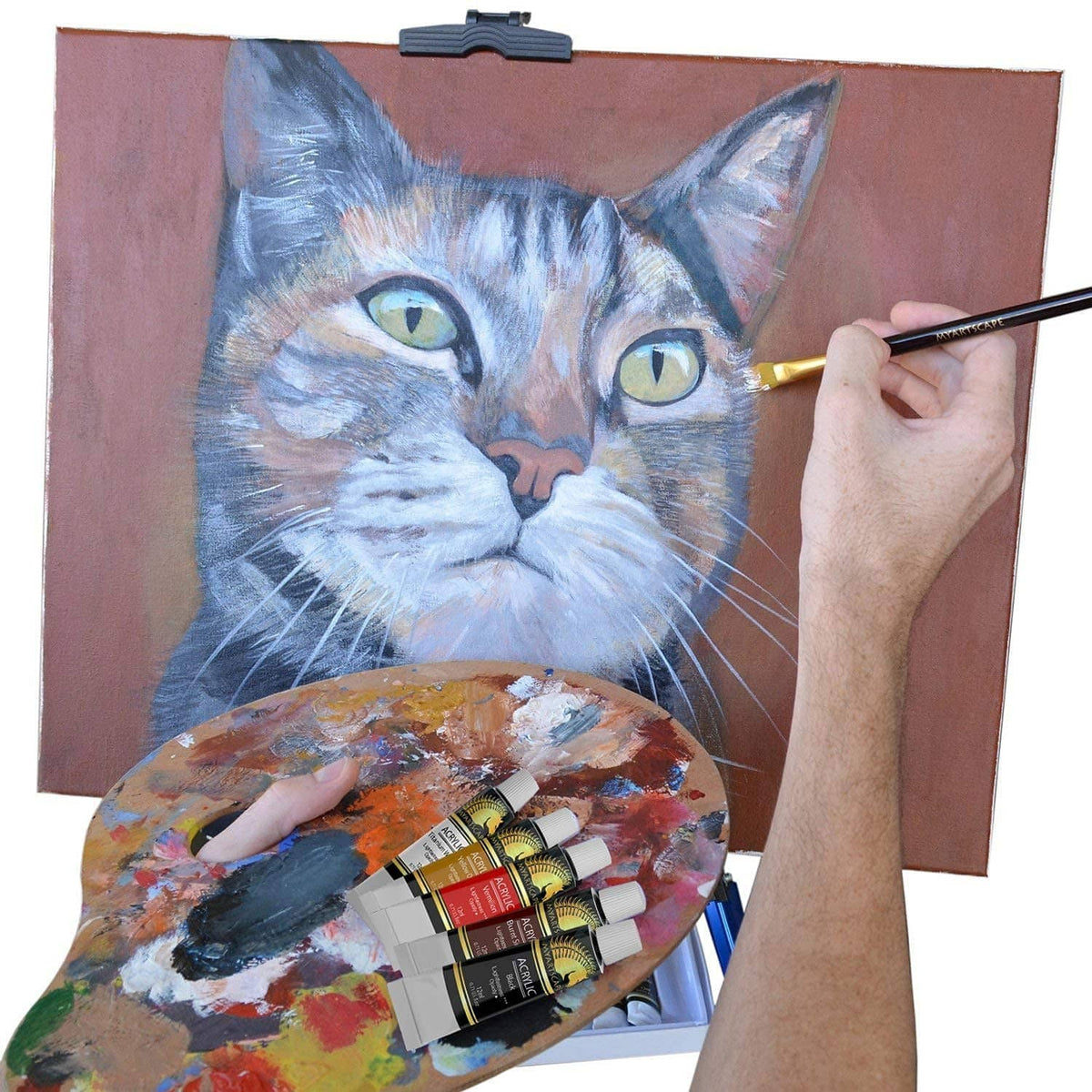 Acrylic painting of a cat portrait on canvas with brush and paint tubes