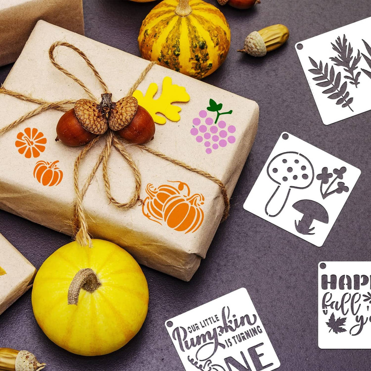 Fall stencil shapes laid on gift wrap, including pumpkin, maple leaf, acorn icons