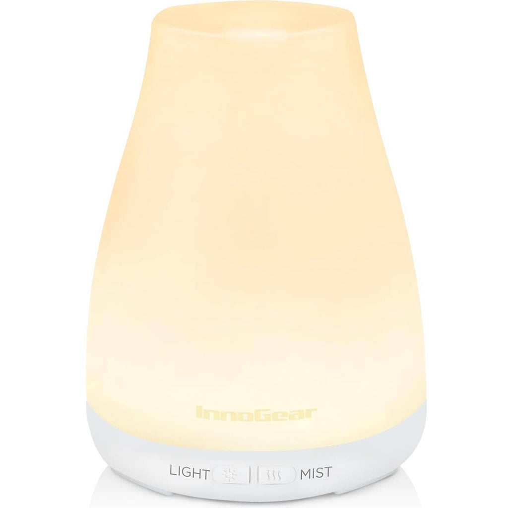 White essential oil diffuser with soft glowing top and mist nozzle base