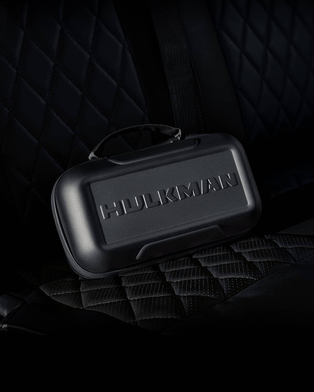 Black EVA protective case on quilted surface with HULKMAN logo panel.