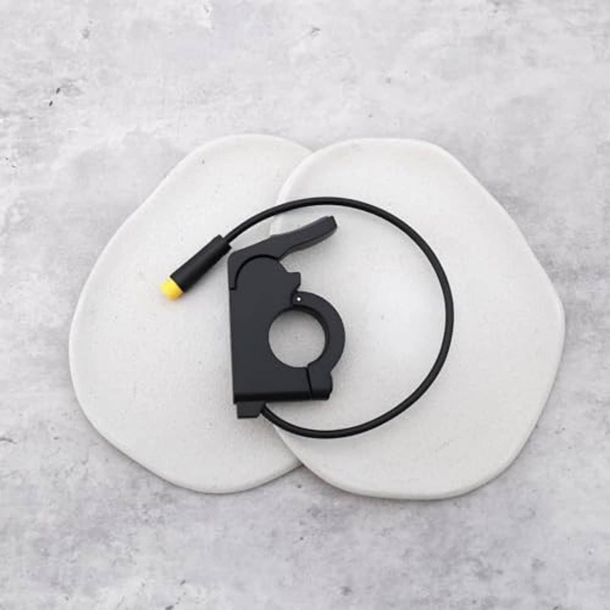 Electric bike thumb throttle component with black clamp, cable, and yellow 3-pin end