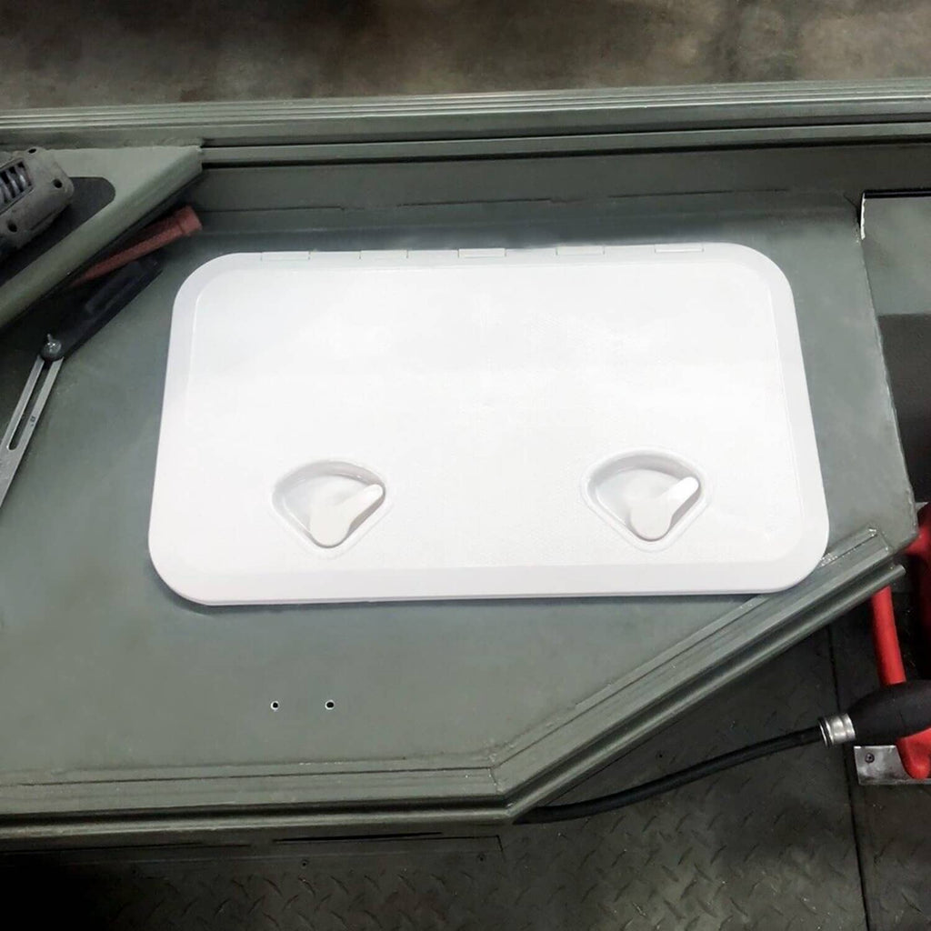 White deck hatch installed on boat deck with lid closed and two hand grips