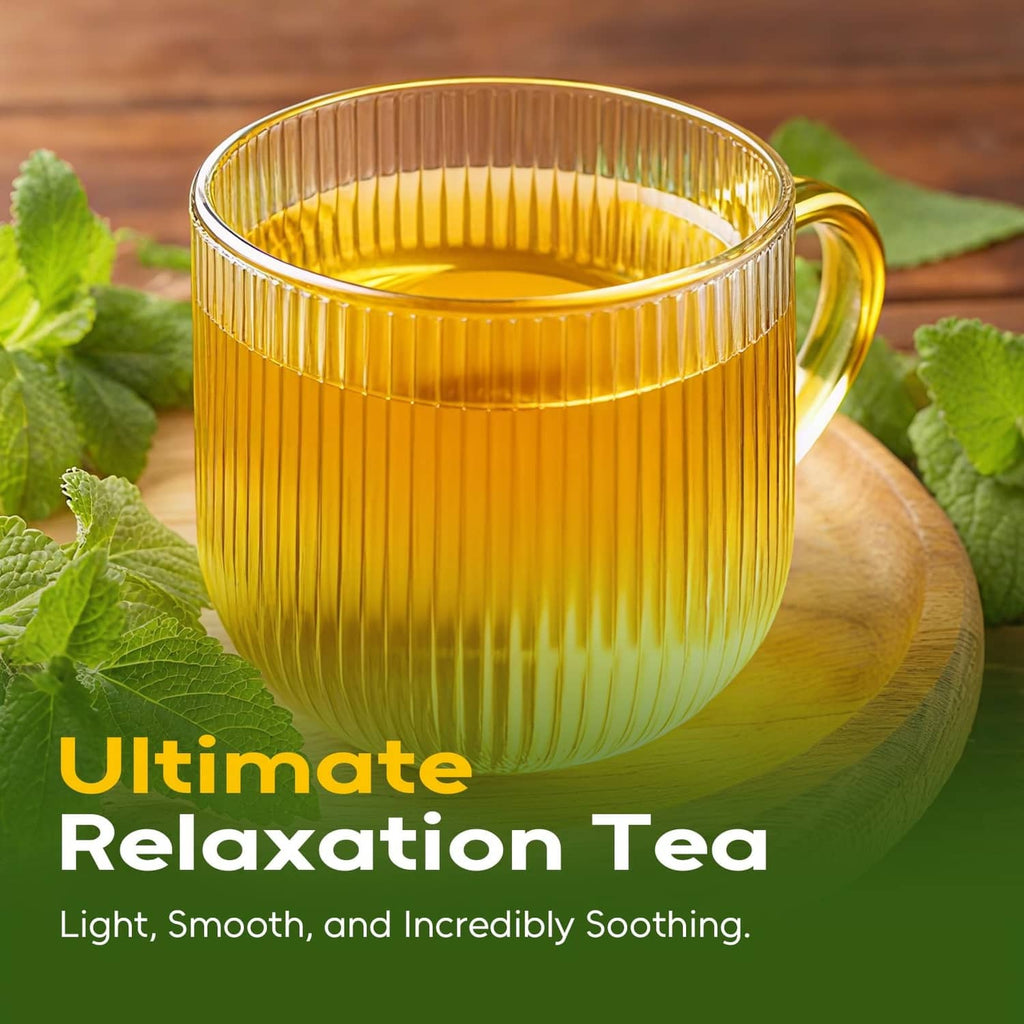Golden amber cup of herbal tea with lemon balm leaves