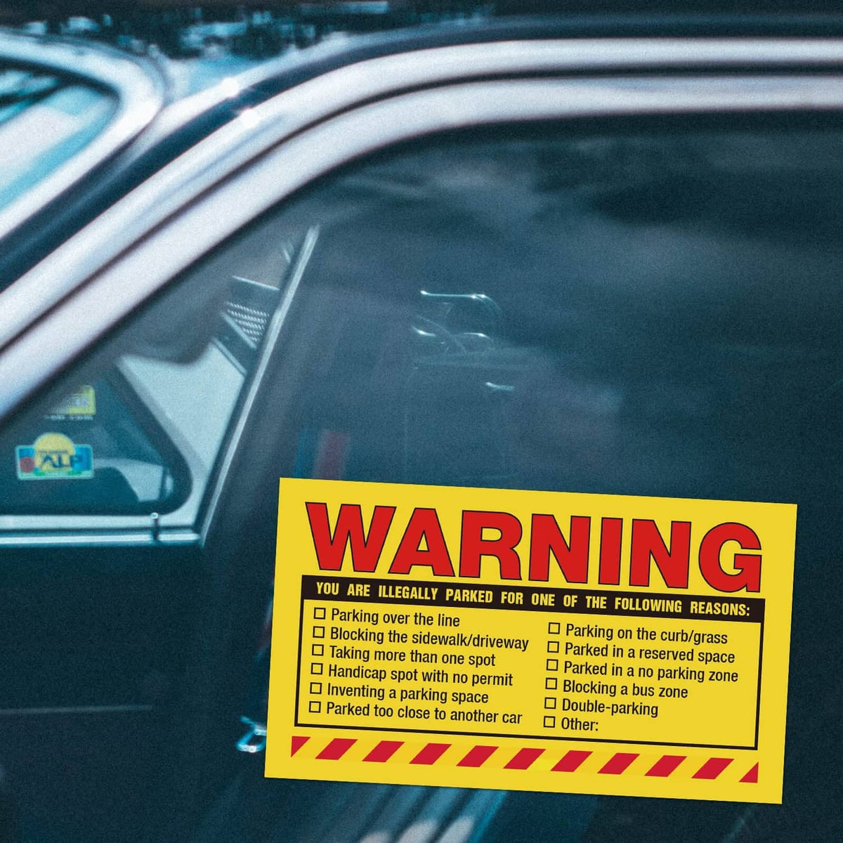 Yellow warning parking violation sticker on car windshield