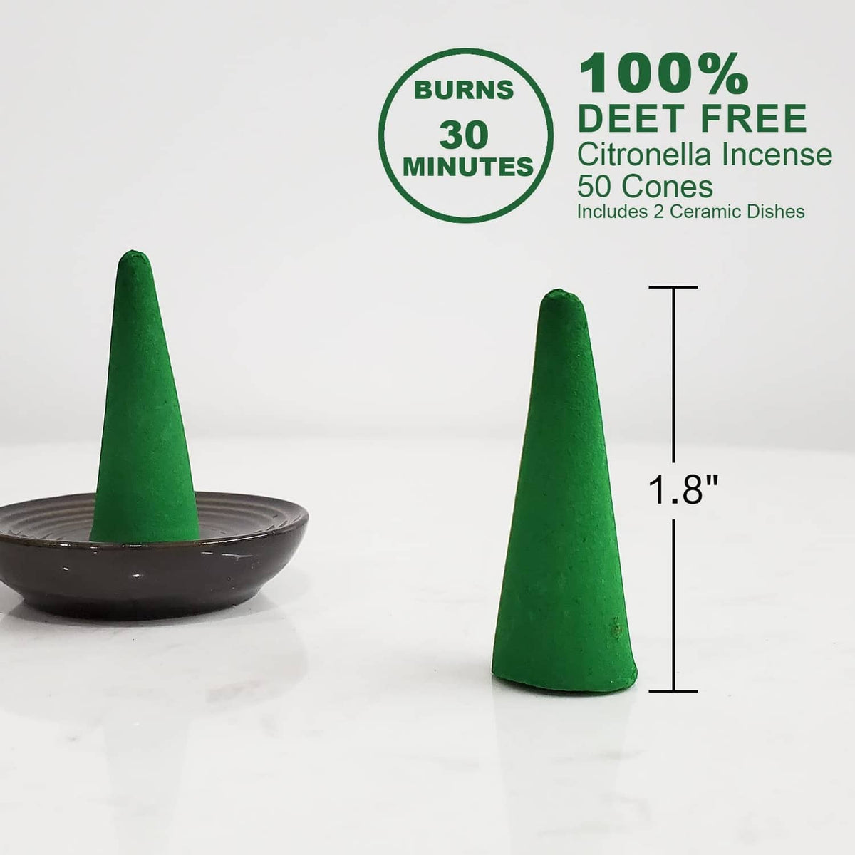 Green incense cones on black ceramic dish, two cones shown upright