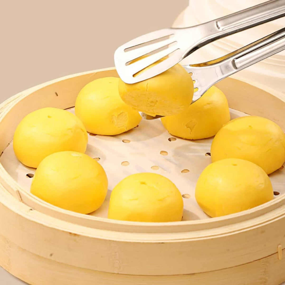 Round white parchment liner with holes covering yellow food in an air fryer
