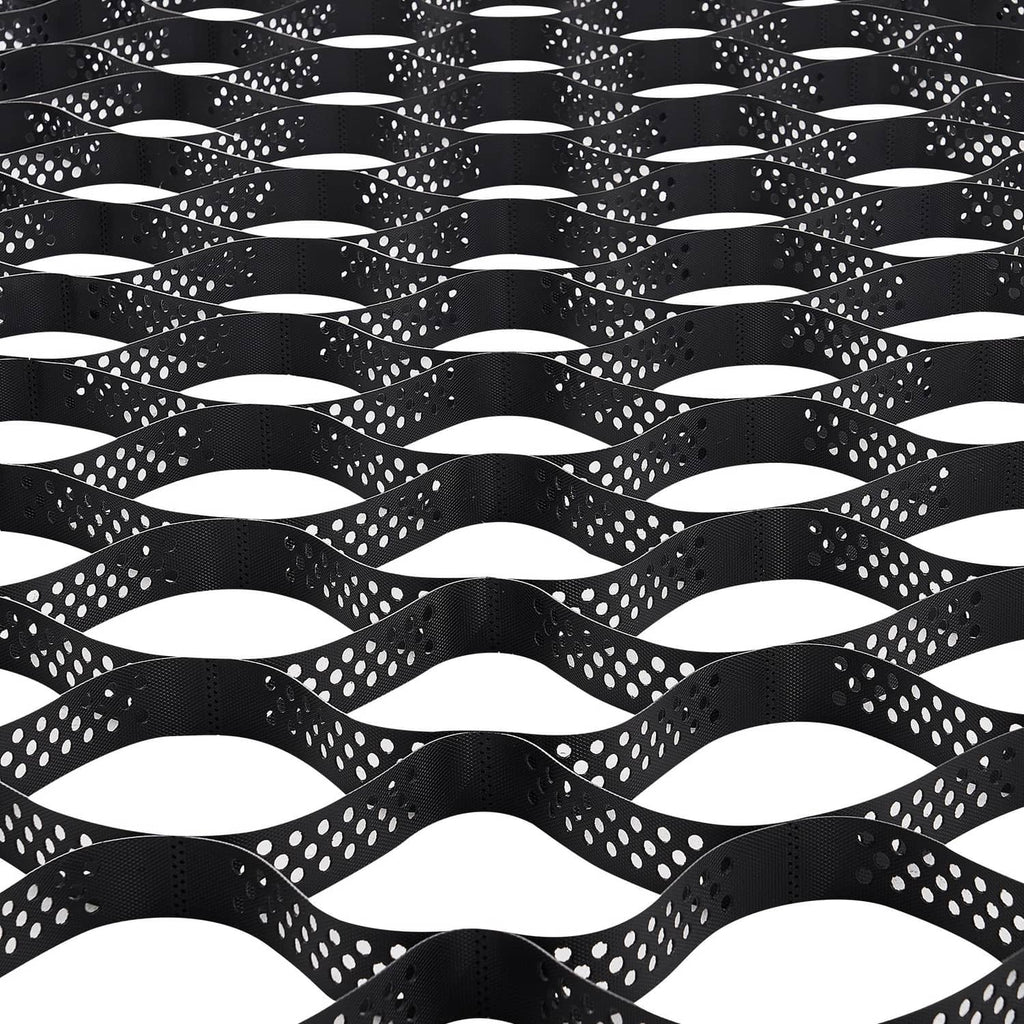 Black geocell ground grid sheet with interlocking wavy cells, shown from above