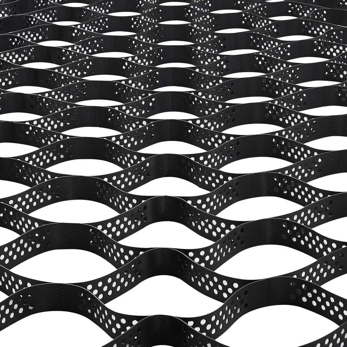 Black geocell ground grid sheet with interlocking wavy cells, shown from above