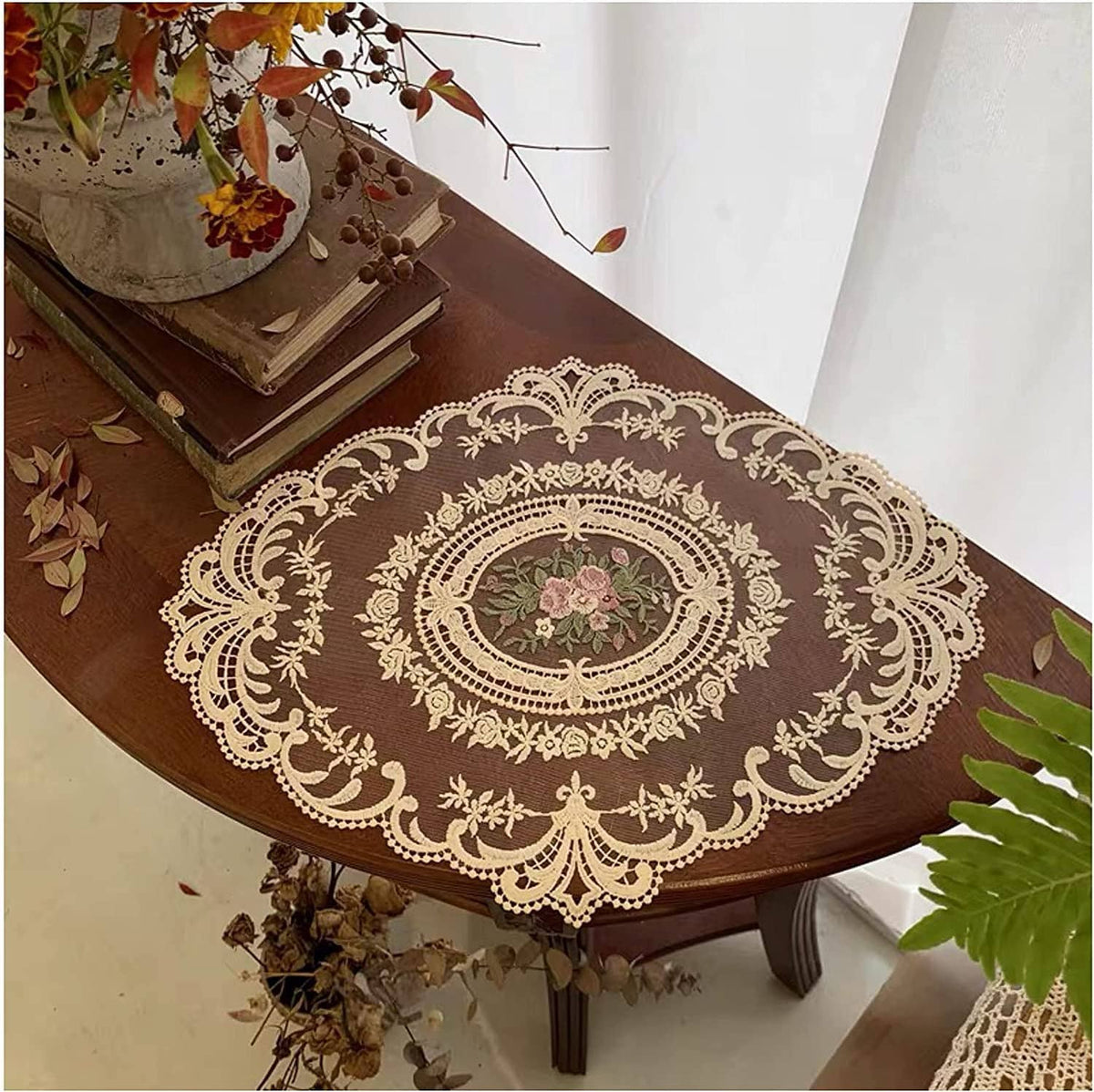 Beige crochet lace placemat with central oval floral motif and decorative border