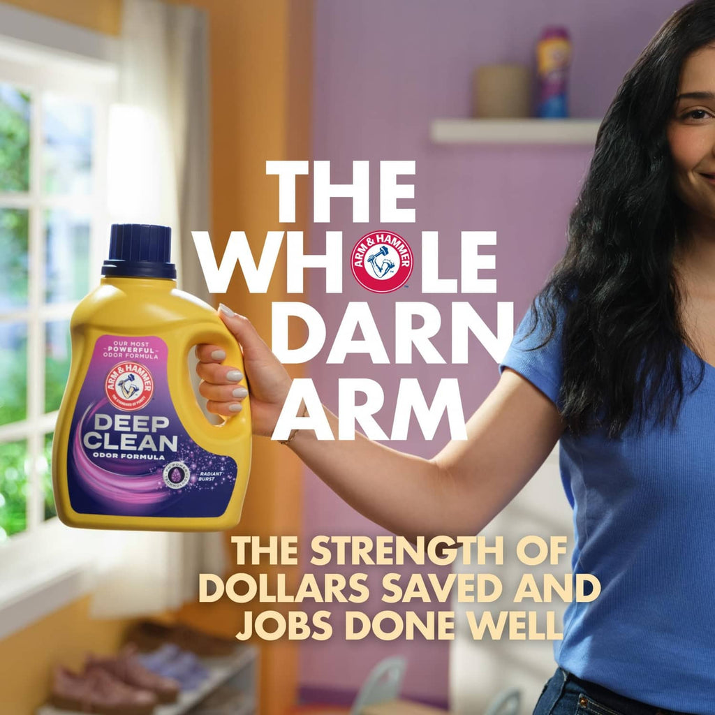 Laundry detergent bottle with purple Deep Clean label, shown being held.