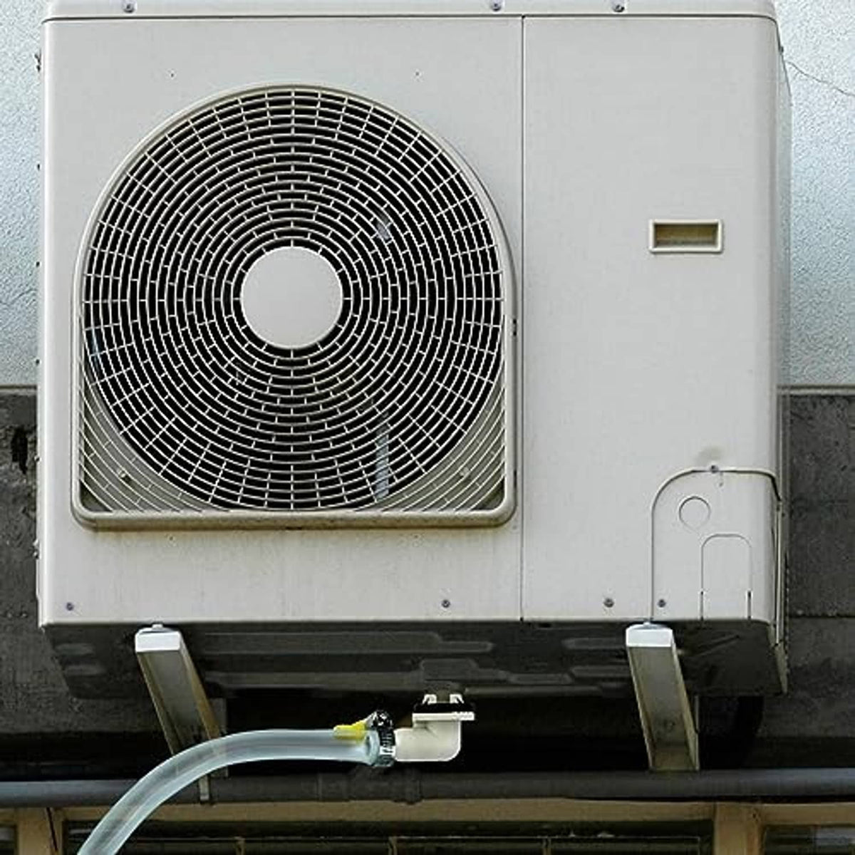 Air conditioner drain hose kit connected to outdoor AC unit drain outlet