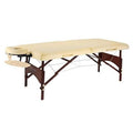 Portable massage table with cream padded top and walnut-brown wooden frame