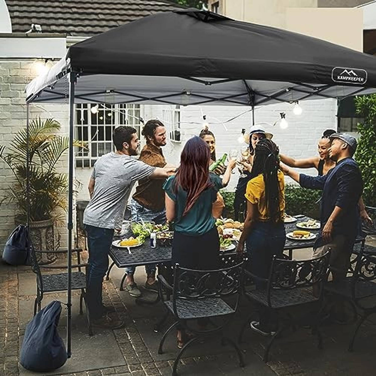 Black pop-up canopy top cover over an event tent frame with hanging light