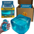Blue stress cube fidget in a hand, glossy teal-blue surface.