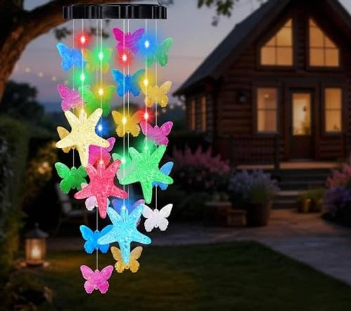 Multicolor butterfly and starfish solar wind chime hanging from a black solar cap