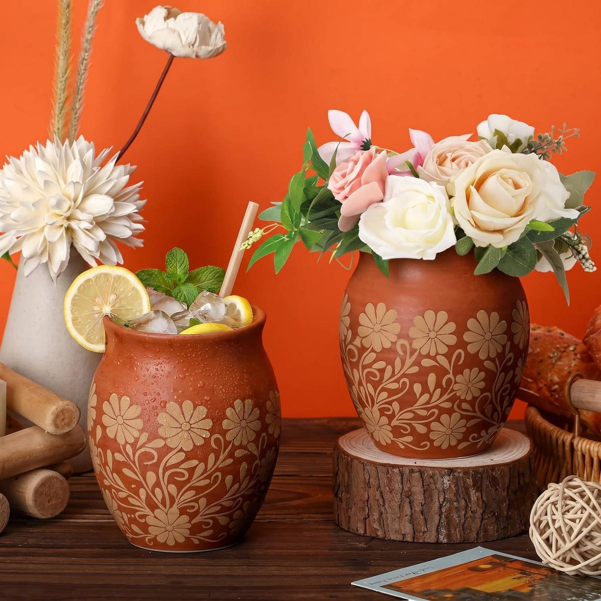 Set of 2 brown Mexican clay cantaritos with white flower pattern, straws, lime garnish