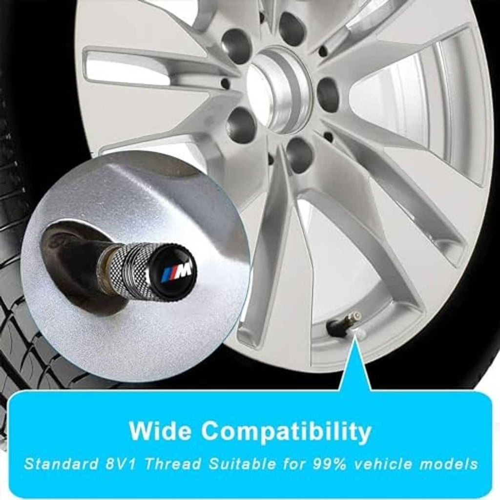 Black knurled valve stem cap with M logo on a wheel rim