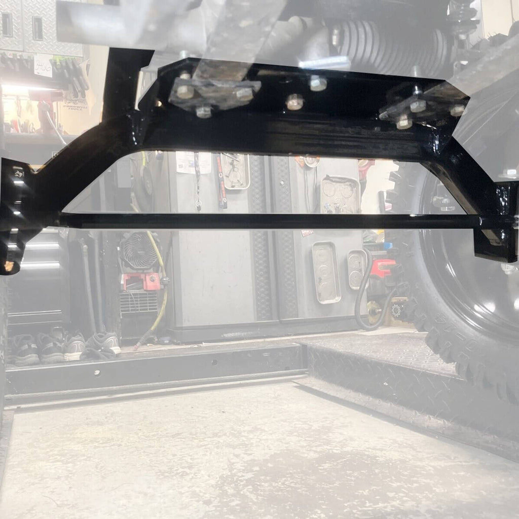 Undercarriage close-up of black axle lift bar and mounting brackets