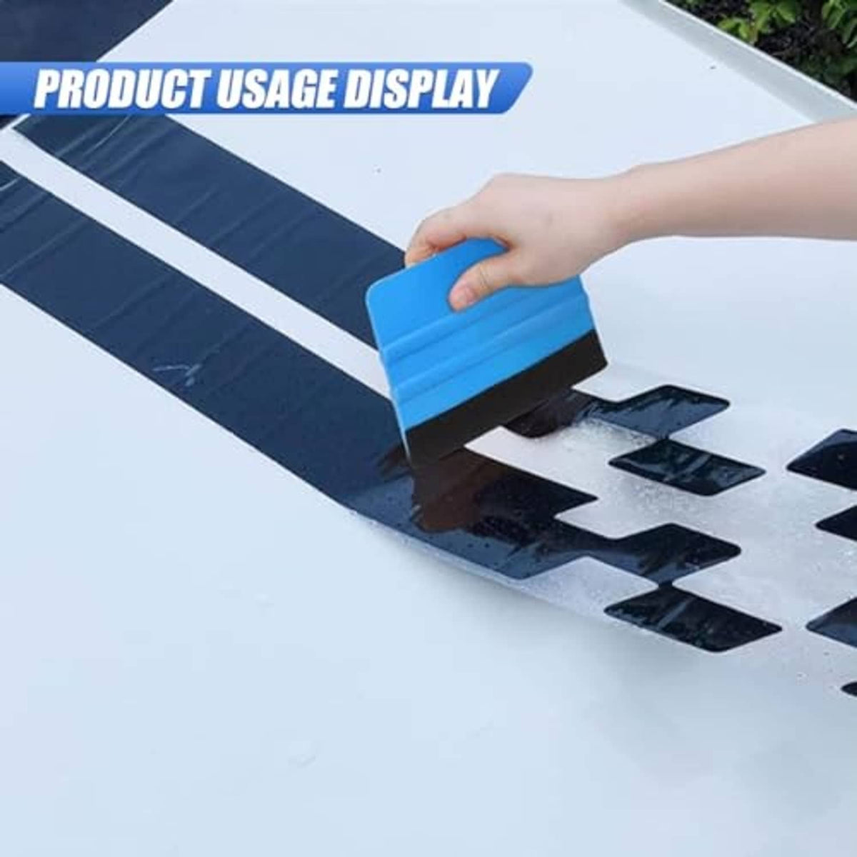 Blue felt-edge squeegee scraper held against the surface by a hand