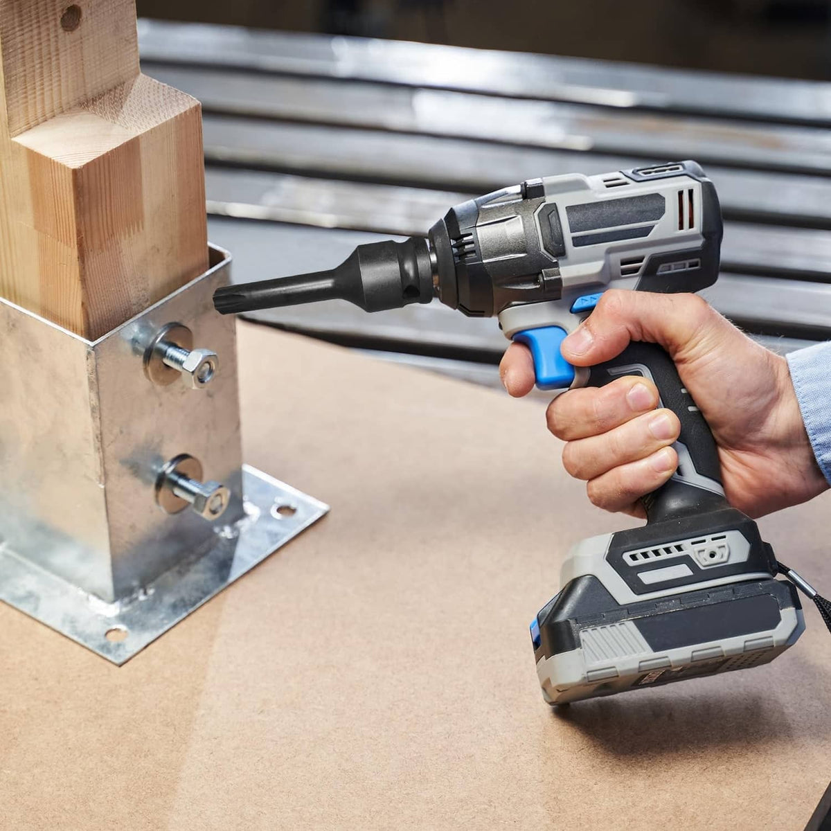 T40 Torx socket bit attached to a 1/2-inch impact driver, black steel
