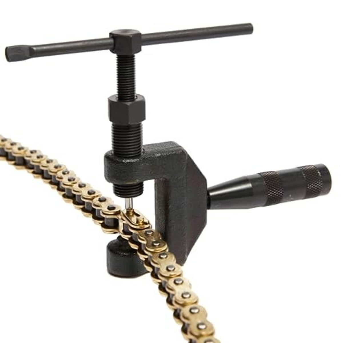Chain breaker tool cutting a gold motorcycle chain link