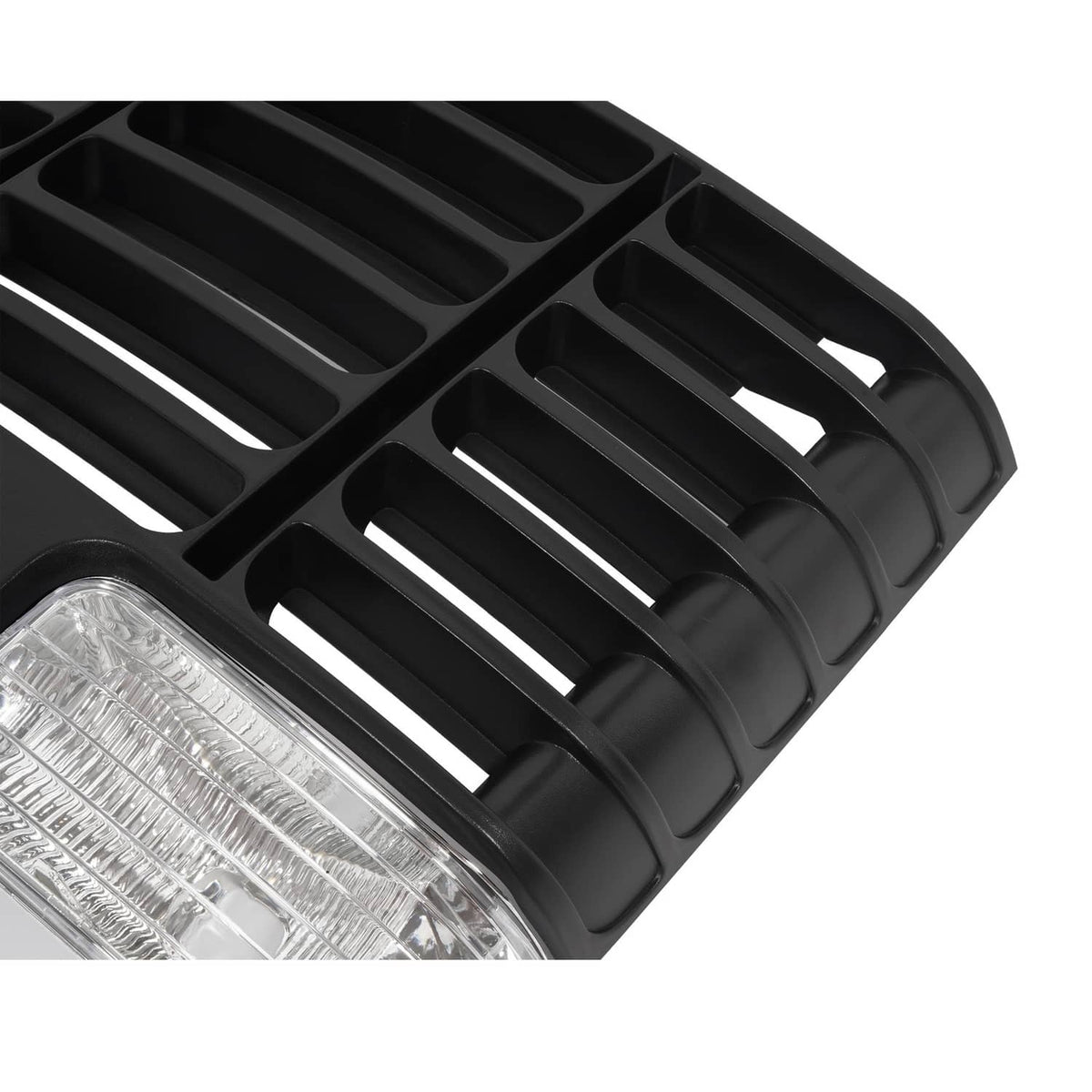 Angled close-up of black ABS grille vent slats and clear headlight lens