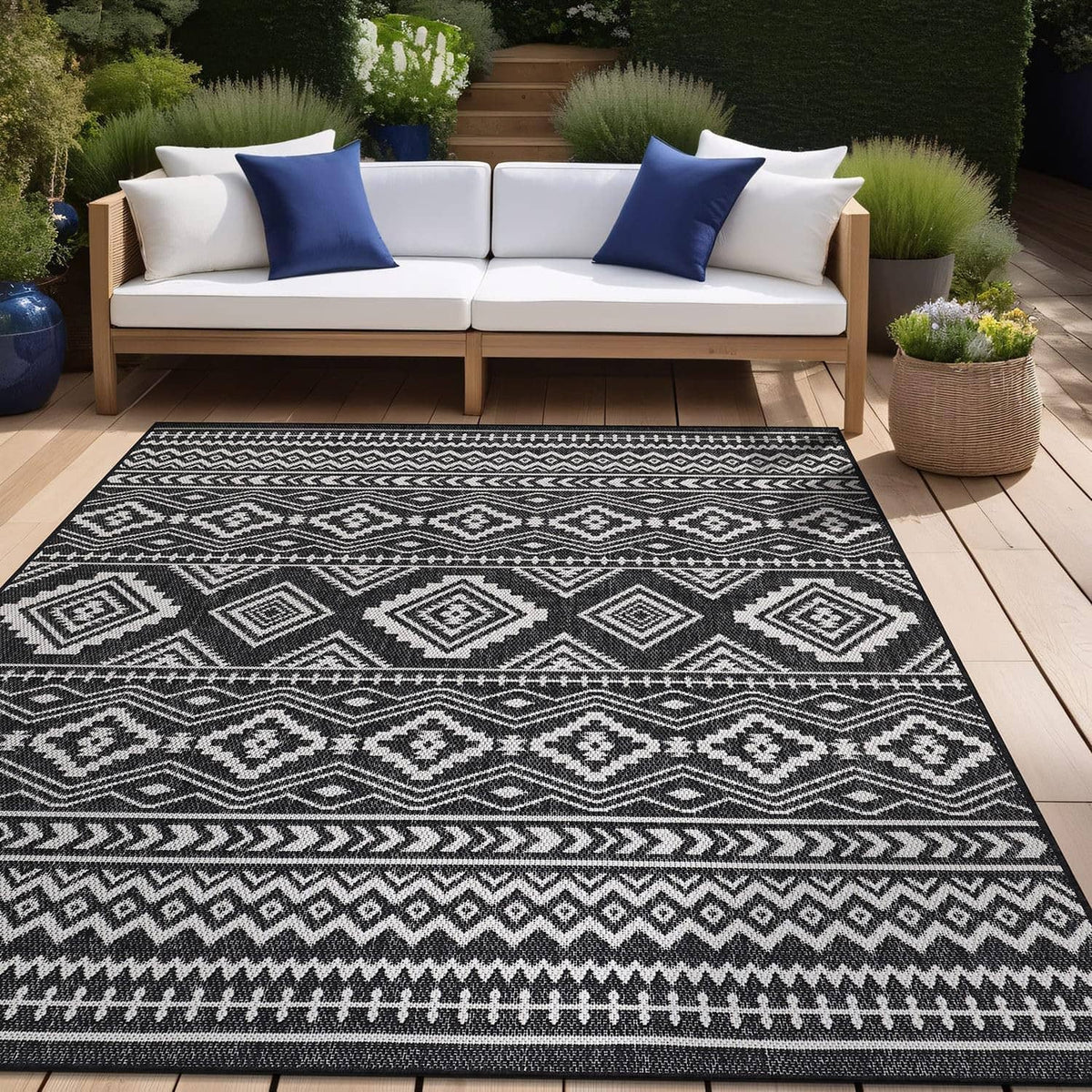Black-and-white boho rug with diamond and zigzag patterns on outdoor patio