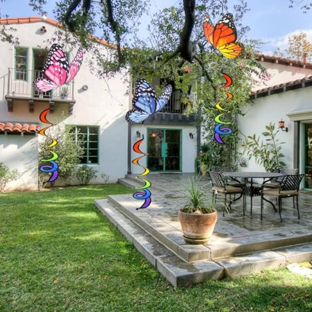 Butterfly garden wind spinners with rainbow curlie spring tails hanging in an outdoor yard