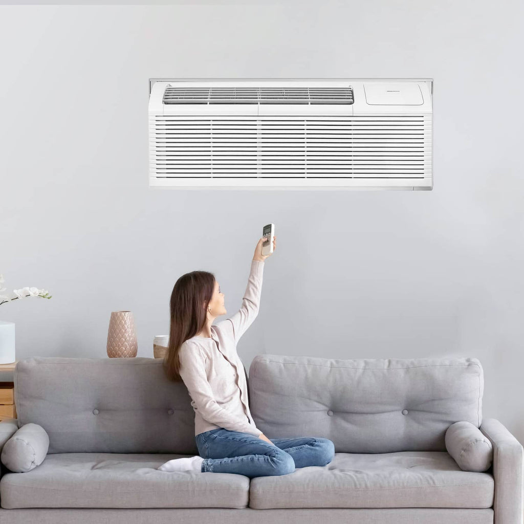 Wall-mounted through-the-wall AC unit with white sleeve trim, grille on front