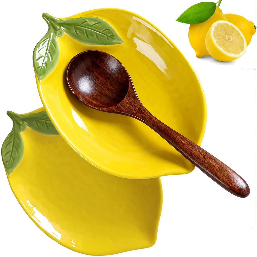Yellow ceramic lemon-shaped spoon rest with two green leaf accents