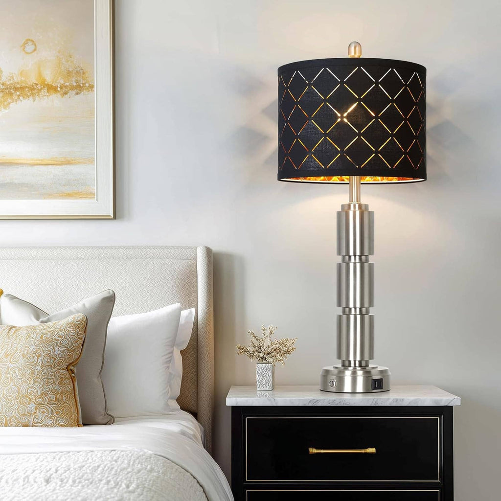 Table lamp with black diamond-pattern shade and brushed metal base on a nightstand