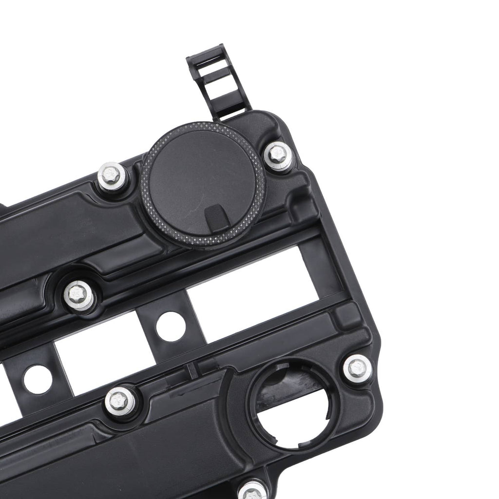 Black valve cover gasket area close-up with round cap and bolt holes