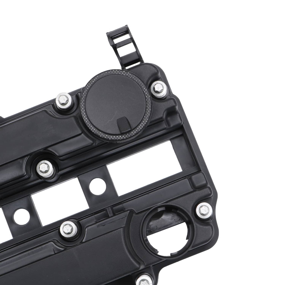 Black valve cover gasket area close-up with round cap and bolt holes