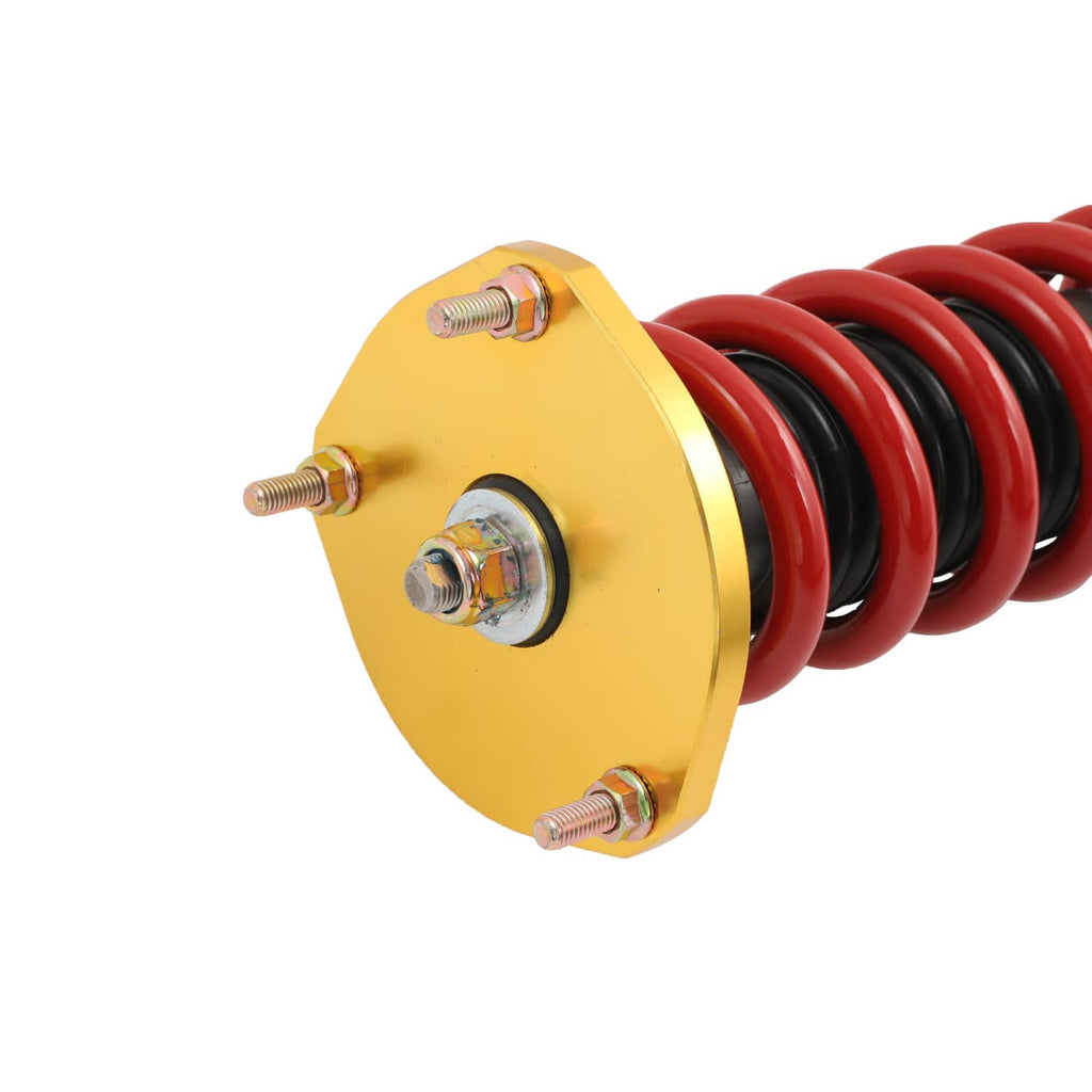 Top mount of coilover strut with red springs and gold spring plate with bolts
