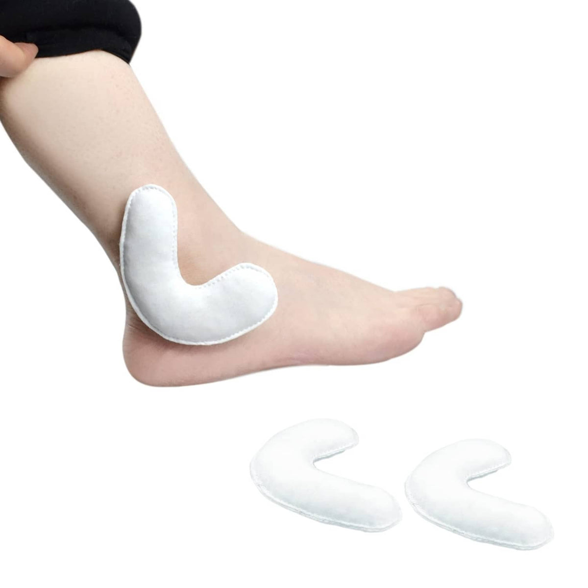 Pair of white ankle pressure pads with curved protective opening for the malleolus