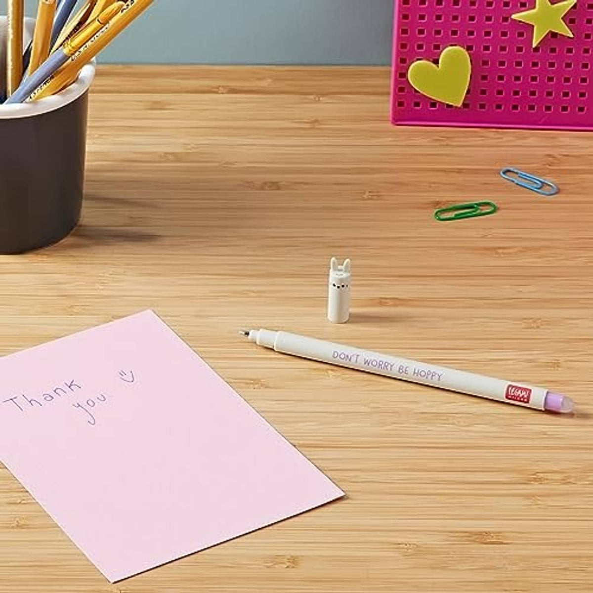 Legami rabbit erasable gel pen on desk, beige barrel with purple tip near greeting paper