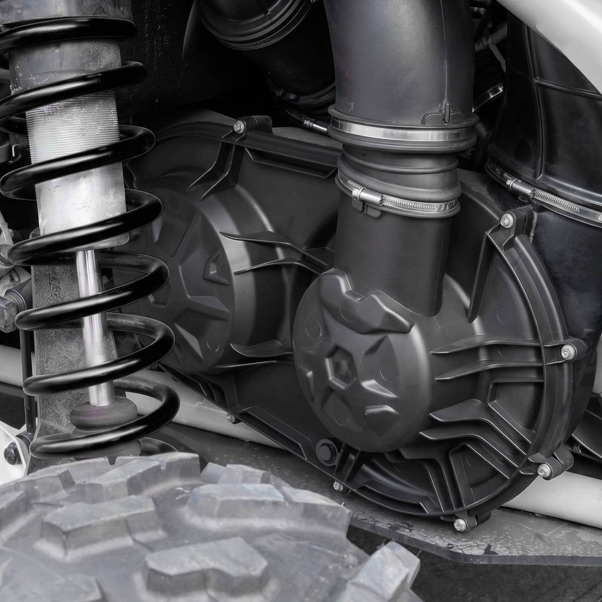 Close-up of black clutch cover with fan wheel, internal fins, and bolts