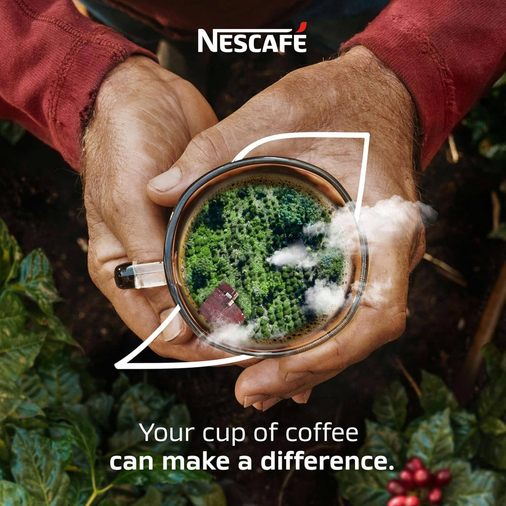 Instant coffee cup filled with green landscape graphic, held in hands