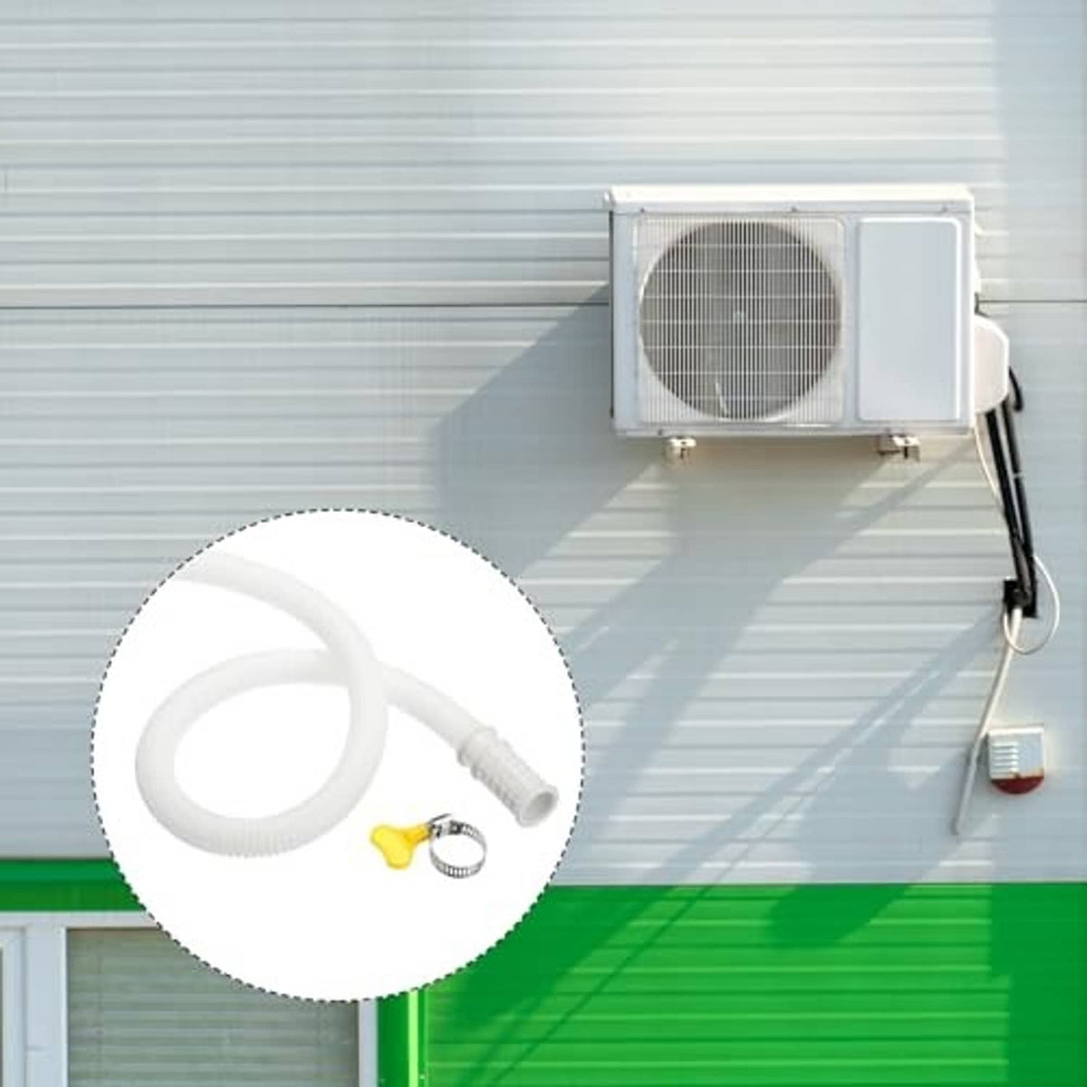 White AC drain hose with clamp and yellow screw fitting connected to equipment