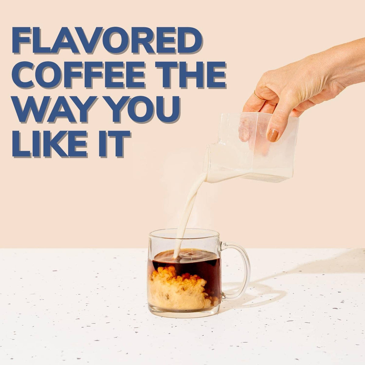 Hazelnut flavored coffee being poured into a mug from a pod