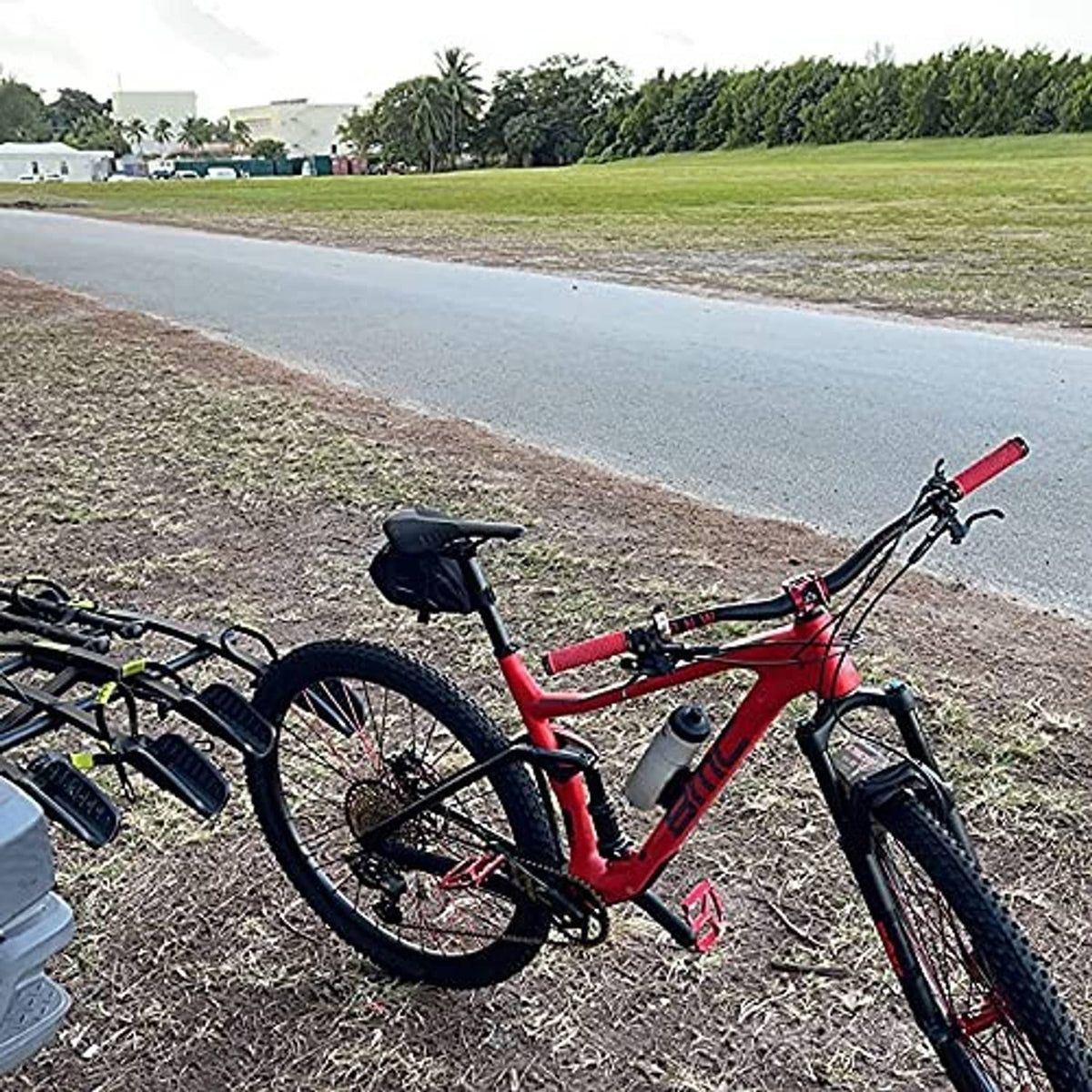 Red mountain bike handlebar grips on a red bike, textured rubber with black end caps