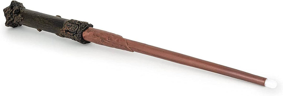 Illuminating magic wand with brown shaft, dark carved grip, and lit white tip