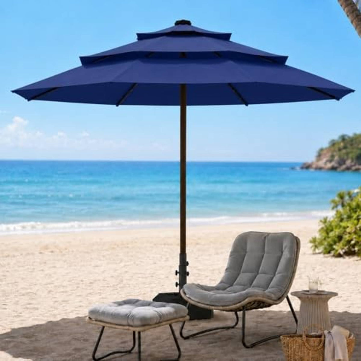 Navy 3-tier vented patio umbrella with central pole and tilted canopy beside lounge set