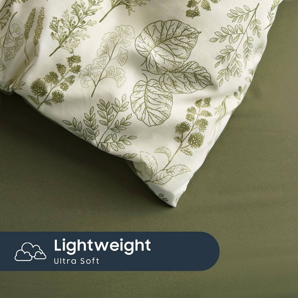 Botanical leaf print comforter corner and pillowcase edge in light fabric