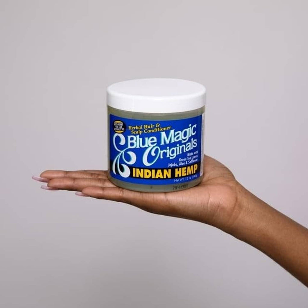 Blue Magic Indian hemp conditioner jar in open hand, white lid over green base